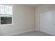 Well-lit bedroom with neutral walls, carpet and double door closet at 2509 Mario Way, Clearwater, FL 33761