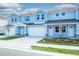 Light blue townhomes with white garage doors and paver driveways at 2509 Mario Way, Clearwater, FL 33761