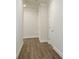 Long hallway with hardwood floors and neutral walls at 2509 Mario Way, Clearwater, FL 33761