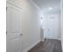 Hallway with hardwood floors and white doors at 2509 Mario Way, Clearwater, FL 33761