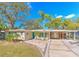 Attractive mid-century modern home with carport and landscaped yard at 8012 N Lynn Ave, Tampa, FL 33604