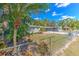 Ranch style home with chain link fence and tropical landscaping at 8012 N Lynn Ave, Tampa, FL 33604