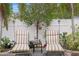 Peaceful backyard with striped lounge chairs and lush greenery at 860 25Th N Ave, St Petersburg, FL 33704