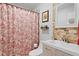 Updated bathroom with patterned shower curtain, stone tile accent wall and modern vanity at 860 25Th N Ave, St Petersburg, FL 33704