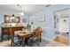 Light and airy dining area with antique furniture and view to entryway at 860 25Th N Ave, St Petersburg, FL 33704