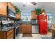 Bright kitchen with stainless steel appliances and a red retro refrigerator at 860 25Th N Ave, St Petersburg, FL 33704