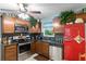 Charming kitchen featuring stainless steel appliances and a red refrigerator at 860 25Th N Ave, St Petersburg, FL 33704