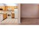Galley kitchen with light wood cabinets and appliances at 11701 Raintree Village Blvd # C, Temple Terrace, FL 33617