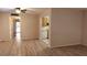 Living room with wood-look floors, kitchen access, and view to entry at 11701 Raintree Village Blvd # C, Temple Terrace, FL 33617