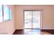 Bright living room with sliding glass doors and hardwood floors at 11701 Raintree Village Blvd # C, Temple Terrace, FL 33617