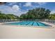 Community swimming pool with lounge chairs at 11701 Raintree Village Blvd # C, Temple Terrace, FL 33617