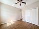 Bedroom with wood-look floors, double closet and ceiling fan at 12403 Ballentrae Forest Dr, Riverview, FL 33579