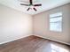 Well-lit bedroom with wood-look floors and window at 12403 Ballentrae Forest Dr, Riverview, FL 33579