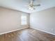 Bedroom with wood-look floors, window, and ceiling fan at 12403 Ballentrae Forest Dr, Riverview, FL 33579