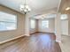 Bright dining room with wood-look floors, chandelier, and large windows at 12403 Ballentrae Forest Dr, Riverview, FL 33579