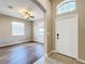 Bright and airy entryway with wood-look floors and neutral walls at 12403 Ballentrae Forest Dr, Riverview, FL 33579