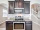 Modern kitchen with dark cabinets, granite countertops and stainless steel appliances at 12403 Ballentrae Forest Dr, Riverview, FL 33579