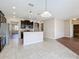 Open kitchen boasting granite counters and dark wood cabinets at 12403 Ballentrae Forest Dr, Riverview, FL 33579