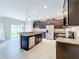 Modern kitchen with dark cabinets, granite counters, and stainless steel appliances at 12403 Ballentrae Forest Dr, Riverview, FL 33579