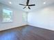 Bright bedroom with ceiling fan and dark gray vinyl flooring at 8113 N Edison Ave, Tampa, FL 33604