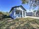 Newly constructed craftsman style home with gray siding, covered porch, and two-car garage at 8113 N Edison Ave, Tampa, FL 33604