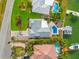 Aerial view of house, pool and dock, on the waterfront at 10088 Paradise Blvd, Treasure Island, FL 33706