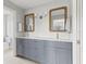 Double vanity bathroom with gray cabinets and quartz countertop at 10088 Paradise Blvd, Treasure Island, FL 33706