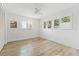 Bright bedroom with wood-look floors and ceiling fan at 10088 Paradise Blvd, Treasure Island, FL 33706