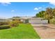 House exterior with brick driveway and landscaping at 10088 Paradise Blvd, Treasure Island, FL 33706