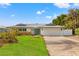 House exterior with brick driveway and landscaping at 10088 Paradise Blvd, Treasure Island, FL 33706