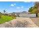 House exterior with brick driveway and landscaping at 10088 Paradise Blvd, Treasure Island, FL 33706