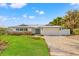 House exterior with brick driveway and landscaping at 10088 Paradise Blvd, Treasure Island, FL 33706