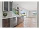 Modern kitchen with wood cabinets, stainless steel appliances and water views at 10088 Paradise Blvd, Treasure Island, FL 33706