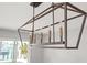 Modern six-light linear chandelier at 10088 Paradise Blvd, Treasure Island, FL 33706