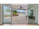 View of the backyard pool and patio area from inside the house at 10088 Paradise Blvd, Treasure Island, FL 33706