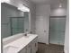 Beautiful bathroom features double sinks, large mirror, and a glass-enclosed shower at 31684 Griffin Sands Ln, San Antonio, FL 33576