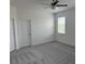 Bright bedroom featuring carpeted floors, a ceiling fan, and a window for natural light at 31684 Griffin Sands Ln, San Antonio, FL 33576