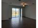 Open-concept living room with hardwood floors and a sliding glass door that leads to a backyard at 31684 Griffin Sands Ln, San Antonio, FL 33576