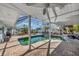 Relaxing screened-in pool area with patio and lush landscape at 43 Leeward Is, Clearwater Beach, FL 33767