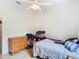 Bright bedroom with double bed and dresser, ceiling fan at 4367 Burns Rd, Brooksville, FL 34602