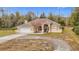 Tan one-story house with arched entryway and landscaping at 4367 Burns Rd, Brooksville, FL 34602