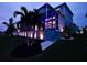 House exterior at night with palm trees and landscape lighting at 5307 Wishing Arch Dr, Apollo Beach, FL 33572