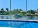 Relaxing pool area with canal view and boat passing by at 5307 Wishing Arch Dr, Apollo Beach, FL 33572