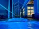 Inviting pool at night with blue lighting and screened enclosure at 5307 Wishing Arch Dr, Apollo Beach, FL 33572