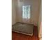 Small bedroom with laminate flooring and a mattress at 6809 N Boulevard, Tampa, FL 33604