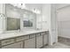 Double vanity bathroom with gray cabinets and walk-in shower at 9433 Barnacle Ln, Parrish, FL 34219