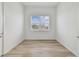 Simple bedroom with wood-look flooring and a window at 9433 Barnacle Ln, Parrish, FL 34219