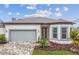 Attractive single-story home with gray garage door and landscaped yard at 9433 Barnacle Ln, Parrish, FL 34219