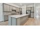 Modern kitchen with gray cabinets, quartz countertops and island at 9433 Barnacle Ln, Parrish, FL 34219