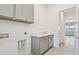 Laundry room with gray cabinets and countertop sink at 9433 Barnacle Ln, Parrish, FL 34219